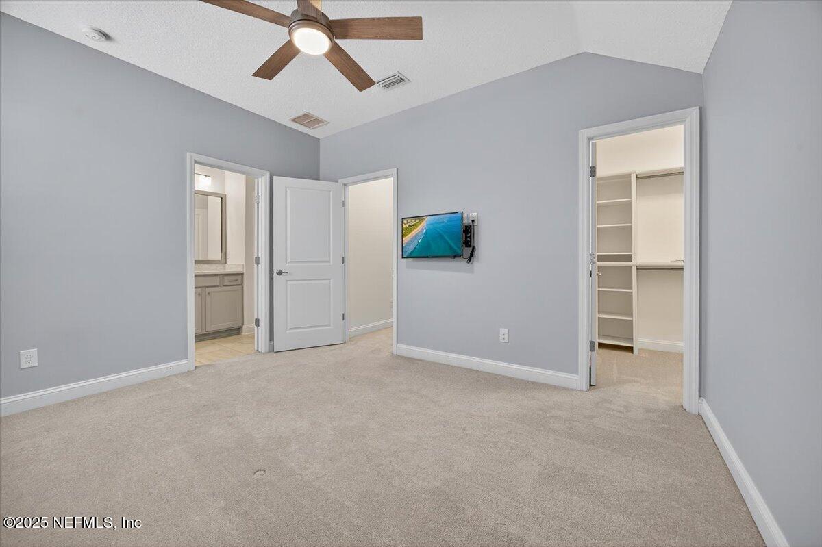 604 Timber Bridge Lane Atlantic Beach, FL 32233 - Photo 29 of 46 an empty room with closet and a ceiling fan
