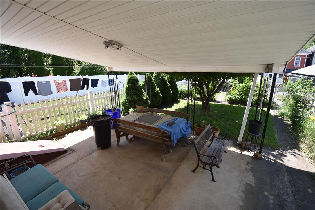 1440 Butler Street Easton, PA 18042 - Photo 17 of 23 A covered concrete patio provides a comfortable outdoor living area overlooking a well-kept yard.