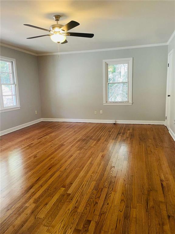 408 Reece Street Northeast Rome, GA 30161 - Photo 3 of 12 an empty room with wooden floor chandelier fan and windows