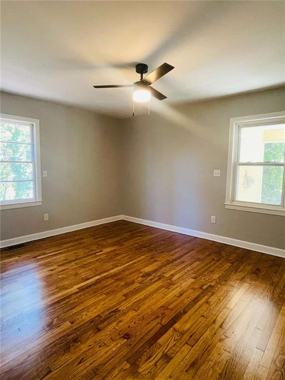 408 Reece Street Northeast Rome, GA 30161 - Photo 6 of 12 a view of an empty room with wooden floor and a window