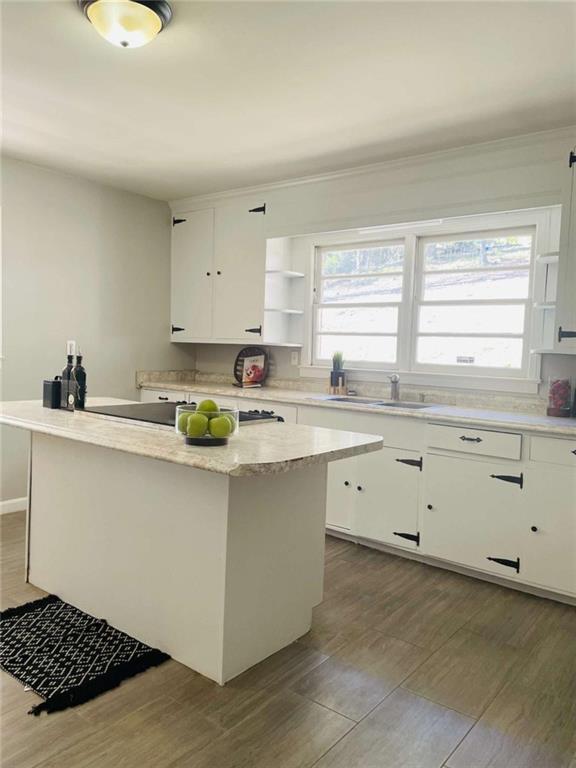 408 Reece Street Northeast Rome, GA 30161 - Photo 7 of 12 a kitchen with cabinets appliances a sink and a window