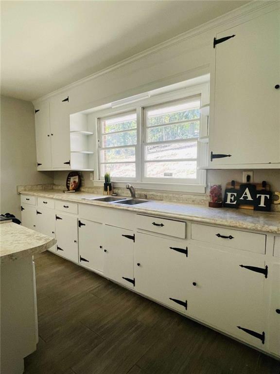 408 Reece Street Northeast Rome, GA 30161 - Photo 8 of 12 a kitchen with granite countertop white cabinets white appliances a sink and a window