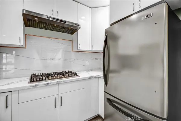 a kitchen with a refrigerator and cabinets