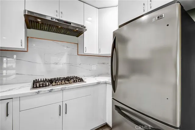 a kitchen with a refrigerator and cabinets