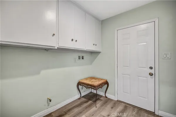 a view of room with a wooden bench and bench