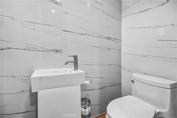 a white toilet sitting next to a bathroom sink
