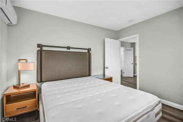 a bedroom with a bed and a chair