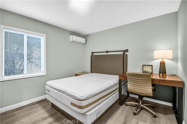 a bedroom with a bed and a desk