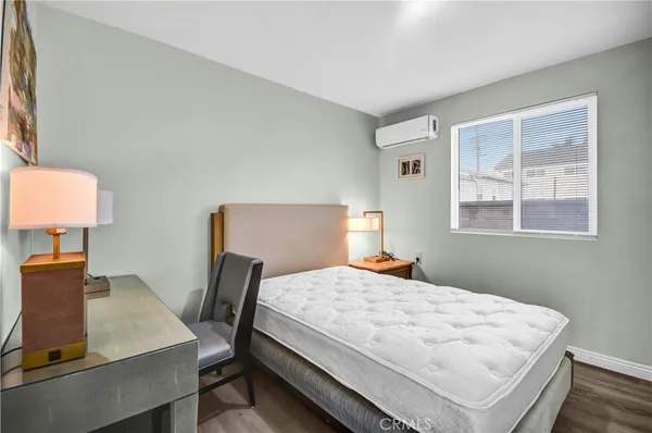 a bedroom with a bed window and table