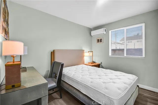 a bedroom with a bed window and table