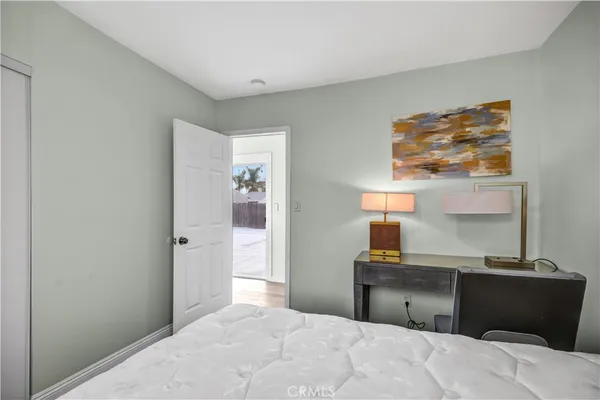 a bedroom with a bed and a lamp on table