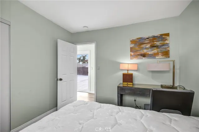 a bedroom with a bed and a lamp on table