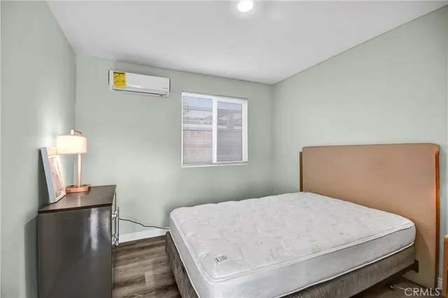 a bedroom with a bed and a tv on table