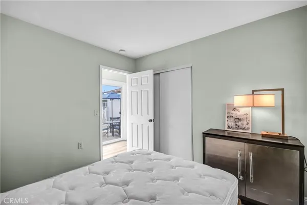 a bedroom with a bed and a mirror