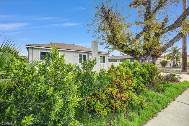 a view of a house with a tree