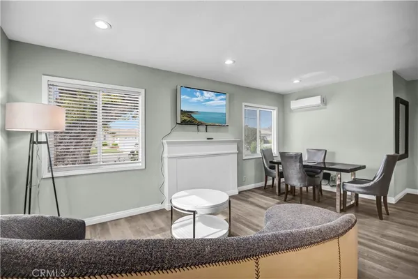 a living room with furniture a window and dining table