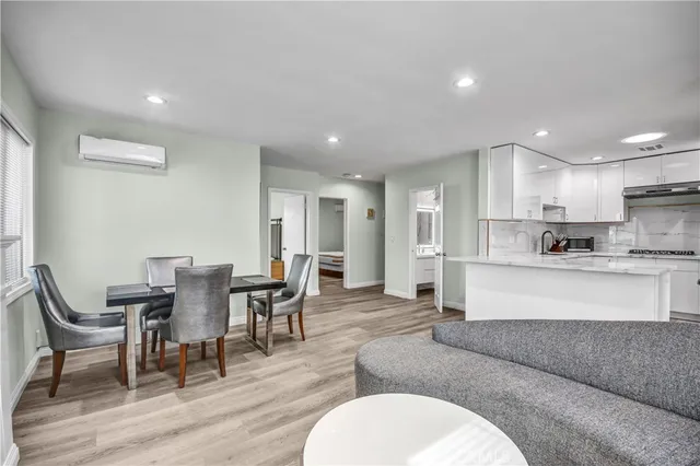 a living room with furniture and kitchen view