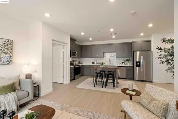 a living room with stainless steel appliances kitchen island granite countertop furniture and a view of kitchen