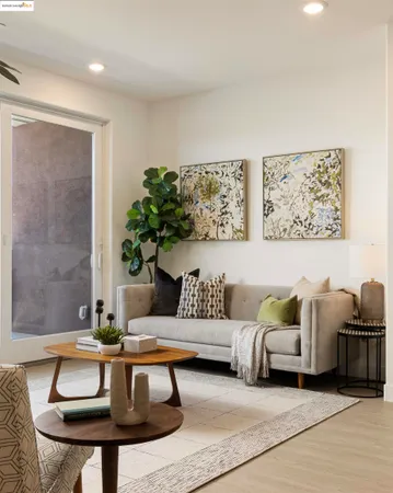 a living room with furniture and a potted plant
