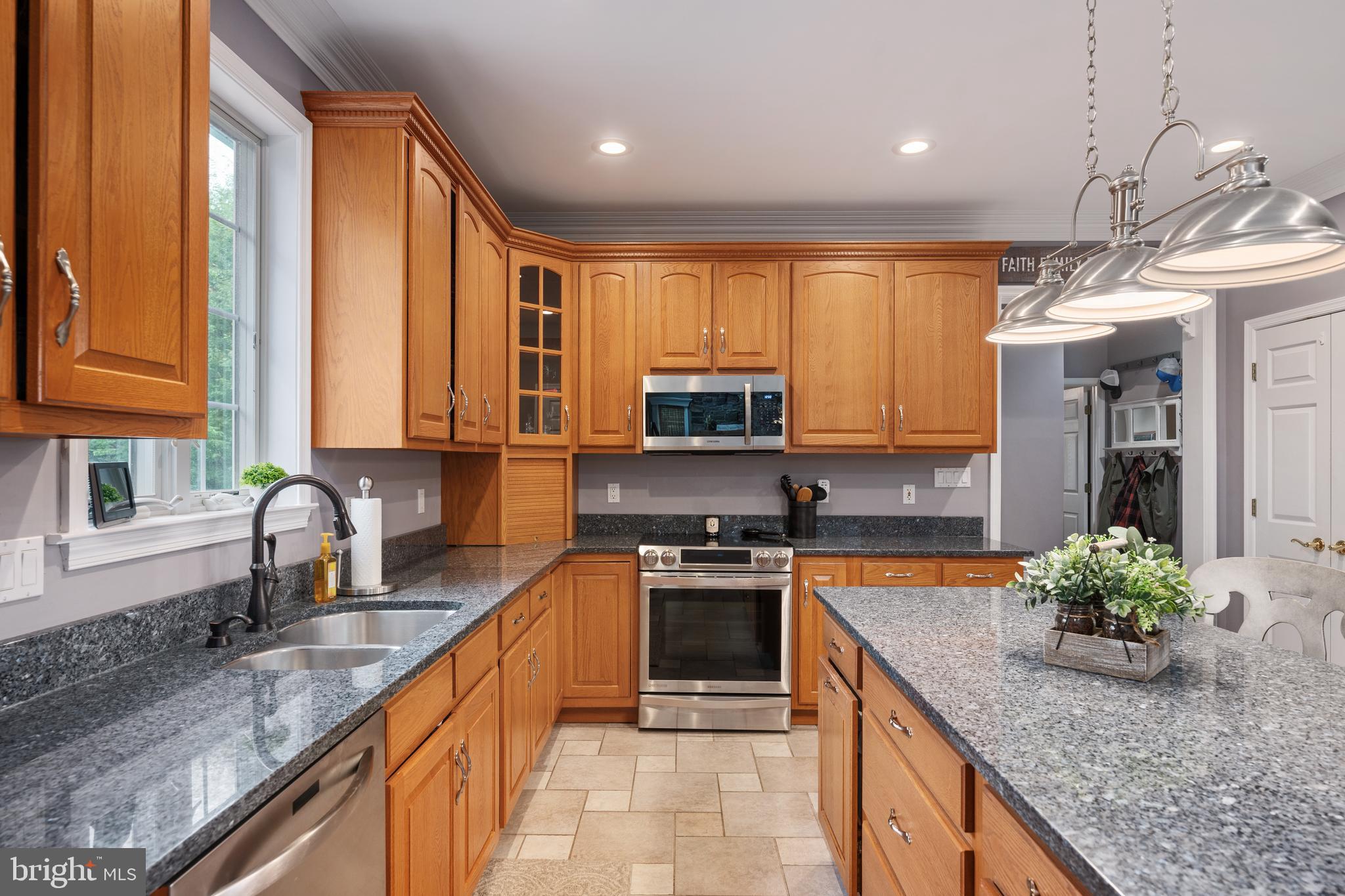 3889 Gamber Road Finksburg, MD 21048 - Photo 13 of 76 a kitchen with stainless steel appliances granite countertop a sink a stove and a wooden cabinets