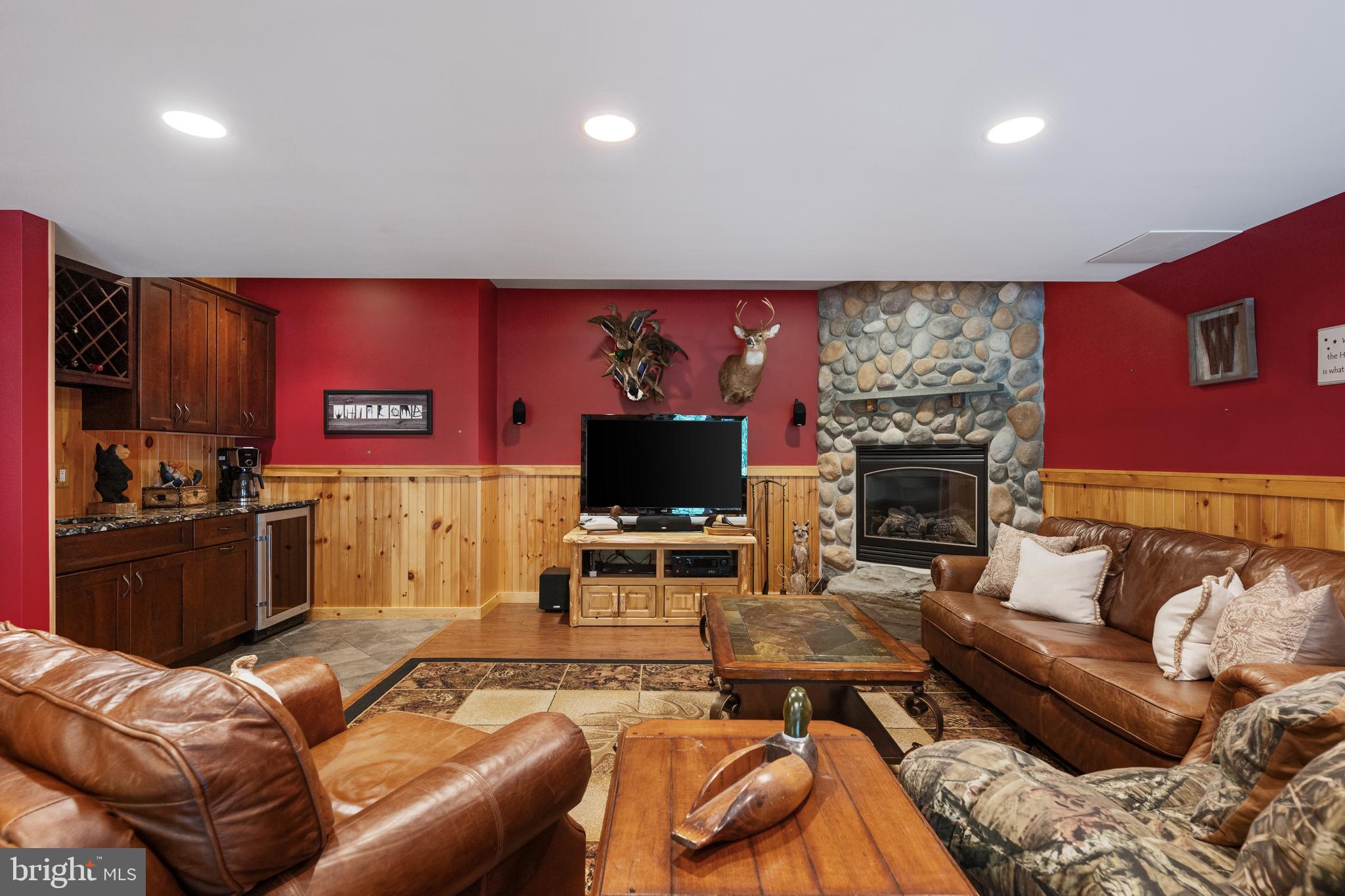 3889 Gamber Road Finksburg, MD 21048 - Photo 42 of 76 a living room with furniture a flat screen tv and a fireplace