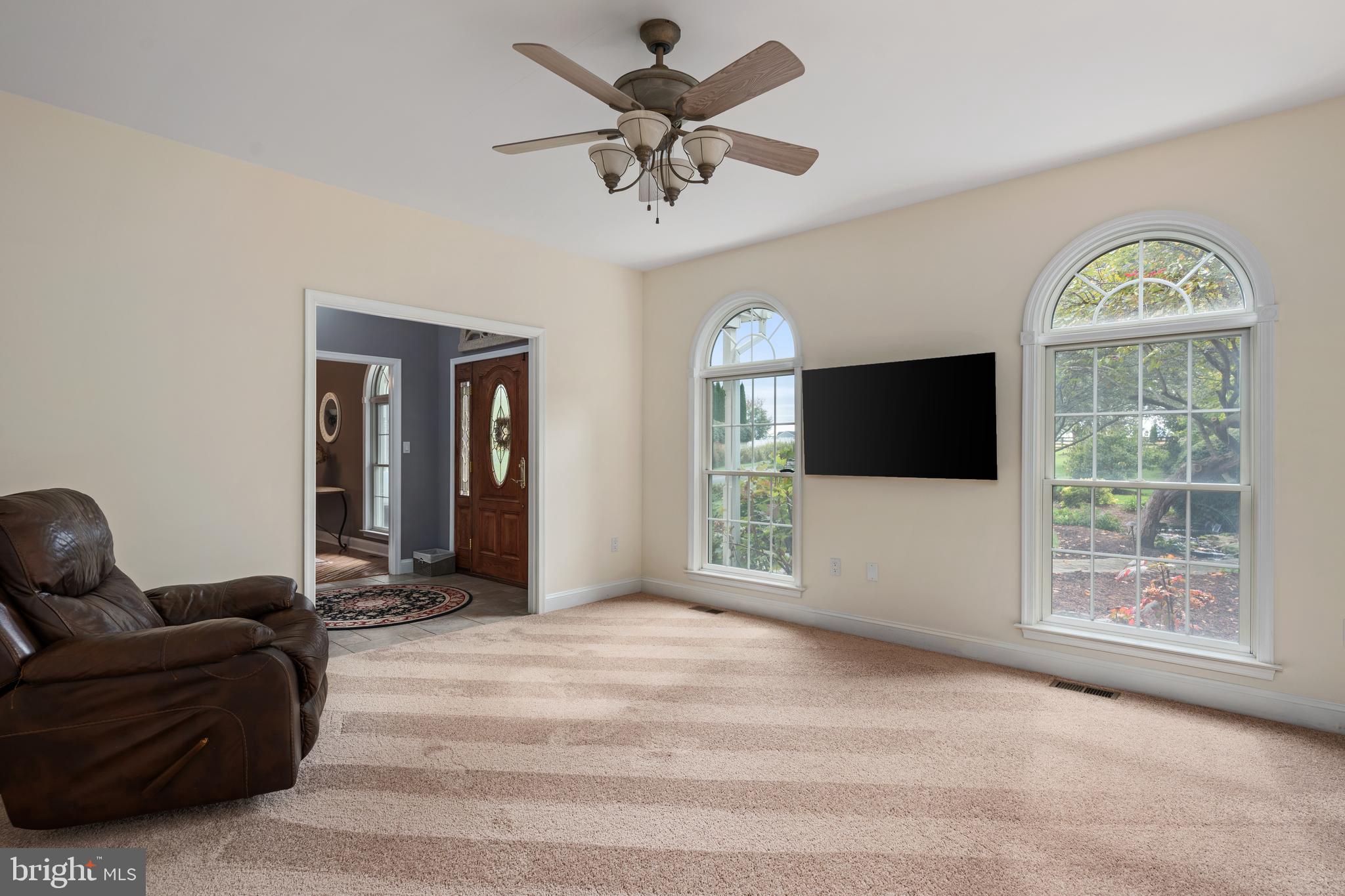 3889 Gamber Road Finksburg, MD 21048 - Photo 8 of 76 a living room with furniture a flat screen tv and a large window