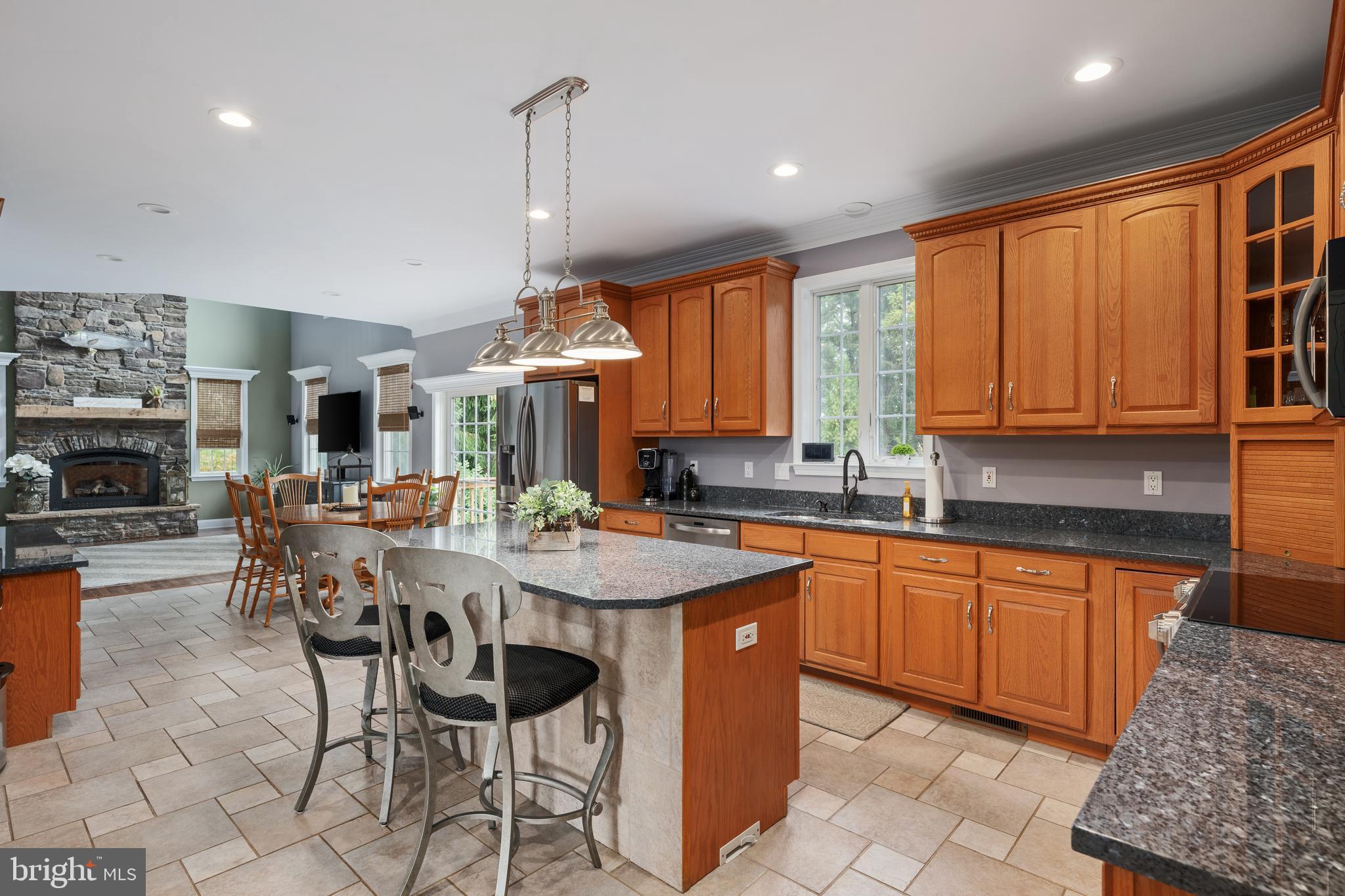 3889 Gamber Road Finksburg, MD 21048 - Photo 10 of 76 a open kitchen with stainless steel appliances granite countertop a table chairs sink and cabinets