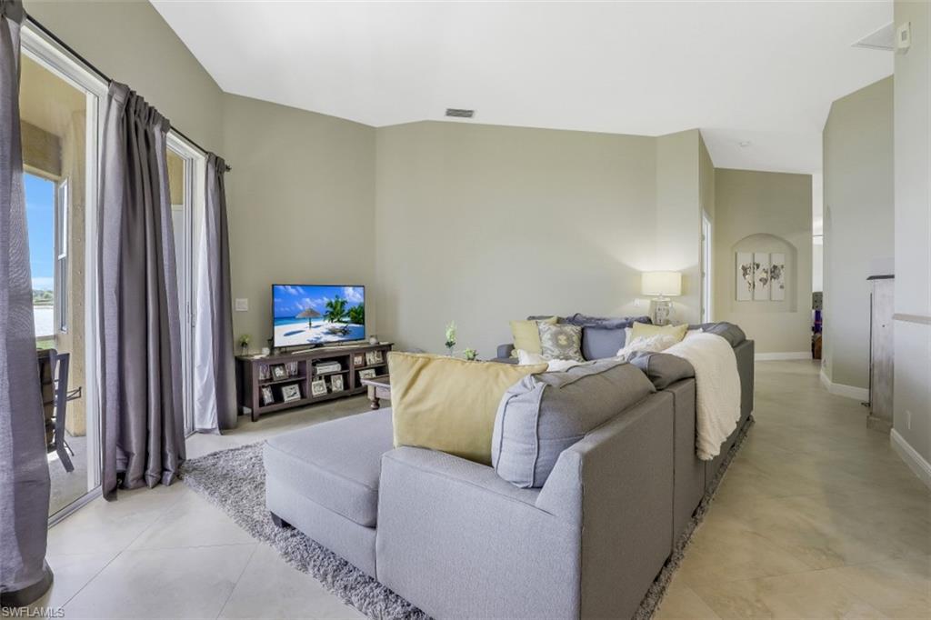 2198 Grove Drive Naples, FL 34120 - Photo 11 of 35 a bed room with furniture and a flat screen tv