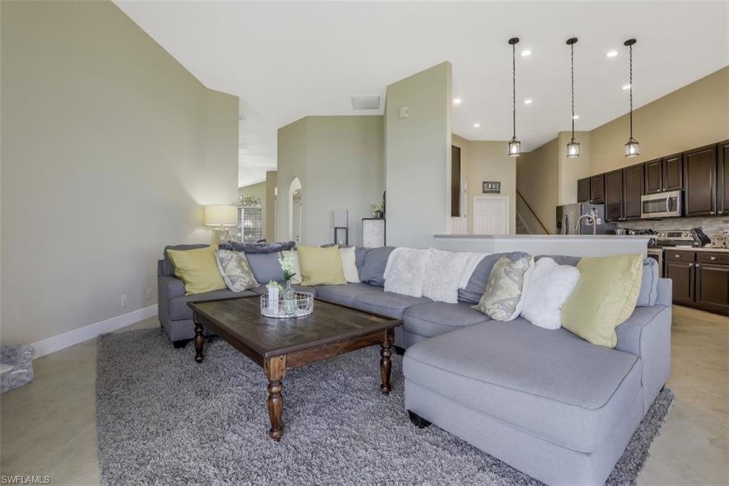 2198 Grove Drive Naples, FL 34120 - Photo 13 of 35 a living room with furniture kitchen and a chandelier