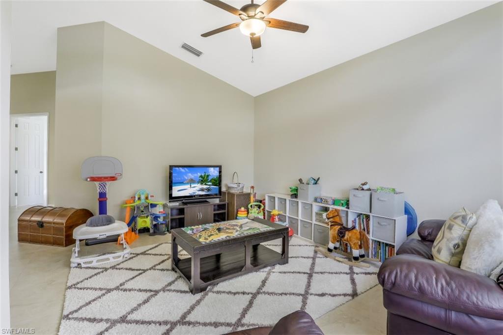 2198 Grove Drive Naples, FL 34120 - Photo 15 of 35 a living room with furniture and a flat screen tv