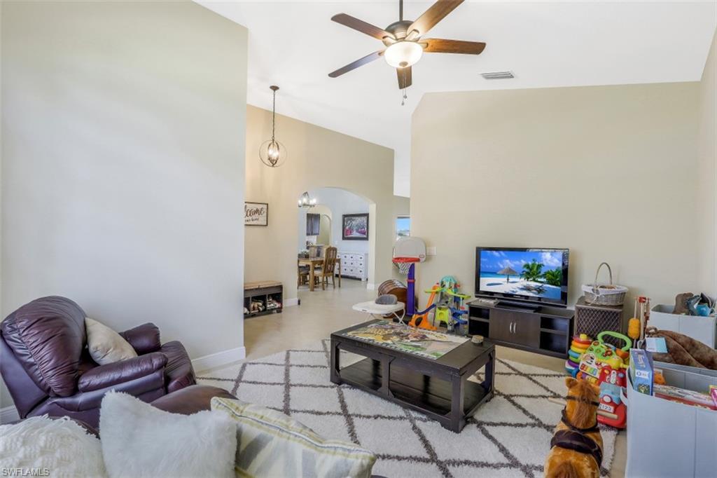 2198 Grove Drive Naples, FL 34120 - Photo 16 of 35 a living room with furniture and a flat screen tv