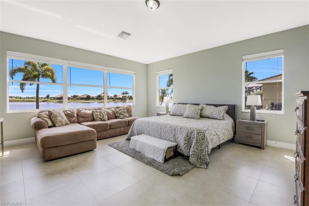 2198 Grove Drive Naples, FL 34120 - Photo 18 of 35 a spacious bedroom with a bed couch and window