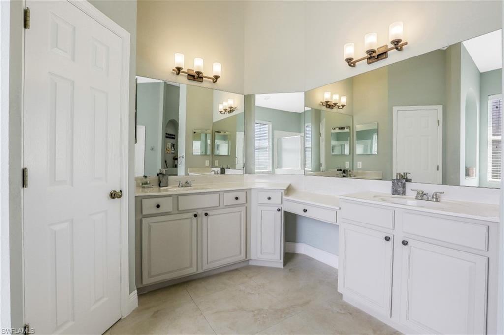 2198 Grove Drive Naples, FL 34120 - Photo 21 of 35 a spacious bathroom with a double vanity sink a mirror and a shower