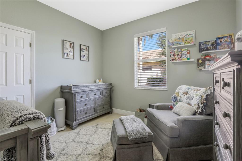 2198 Grove Drive Naples, FL 34120 - Photo 24 of 35 a bedroom with a bed and a window