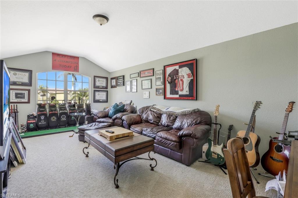 2198 Grove Drive Naples, FL 34120 - Photo 27 of 35 a living room with furniture and a flat screen tv