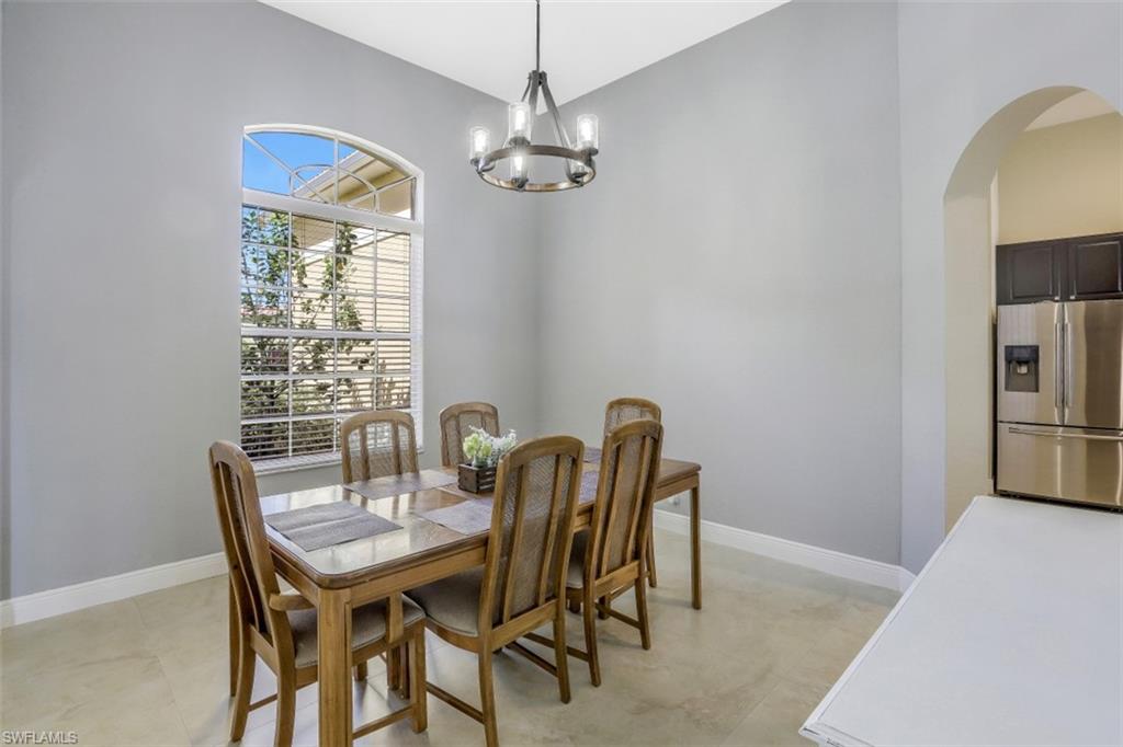 2198 Grove Drive Naples, FL 34120 - Photo 3 of 35 a view of a dining room with furniture and a chandelier