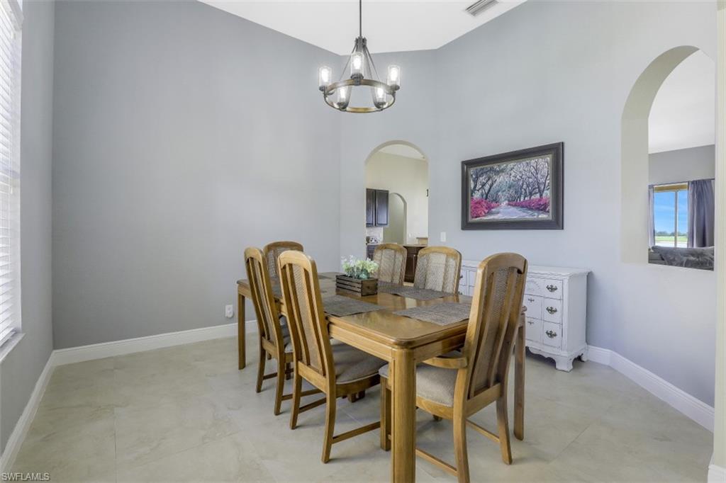2198 Grove Drive Naples, FL 34120 - Photo 4 of 35 a view of a dining room with furniture and chandelier