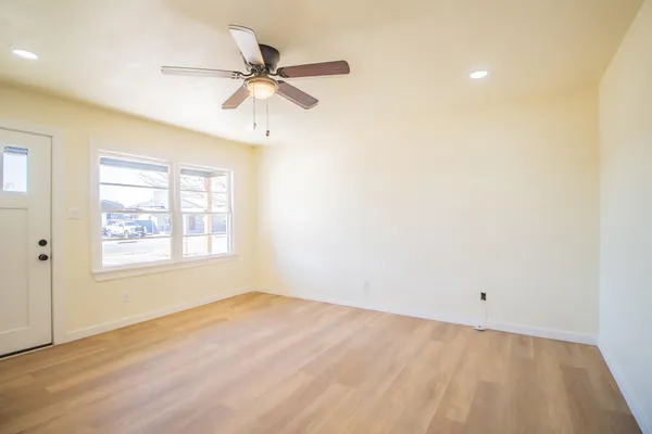a view of a room with a ceiling fan