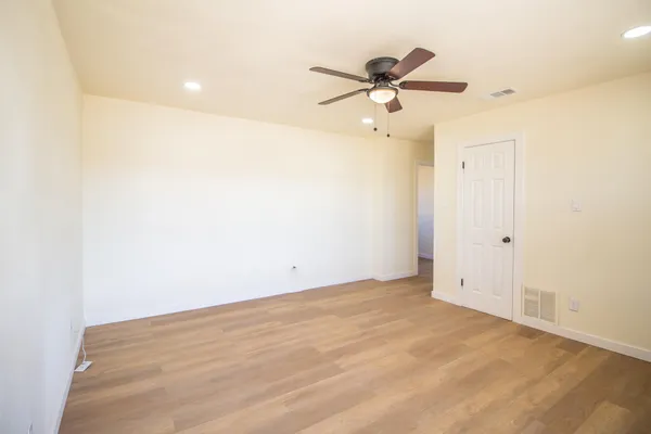 a view of a kitchen with refrigerator and a sink