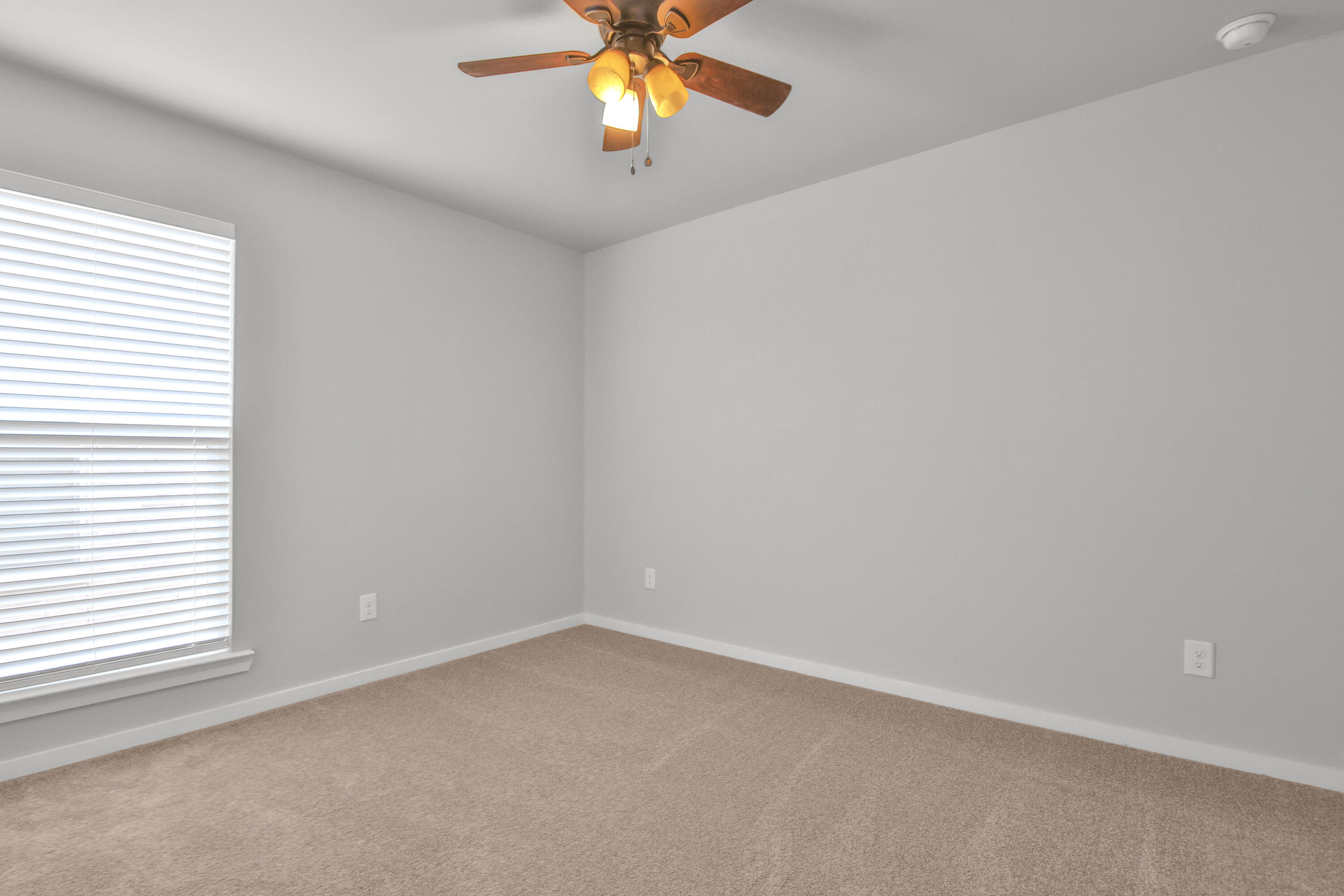 7526 104th Street Lubbock, TX 79424 - Photo 19 of 28 an empty room with a window and a fan