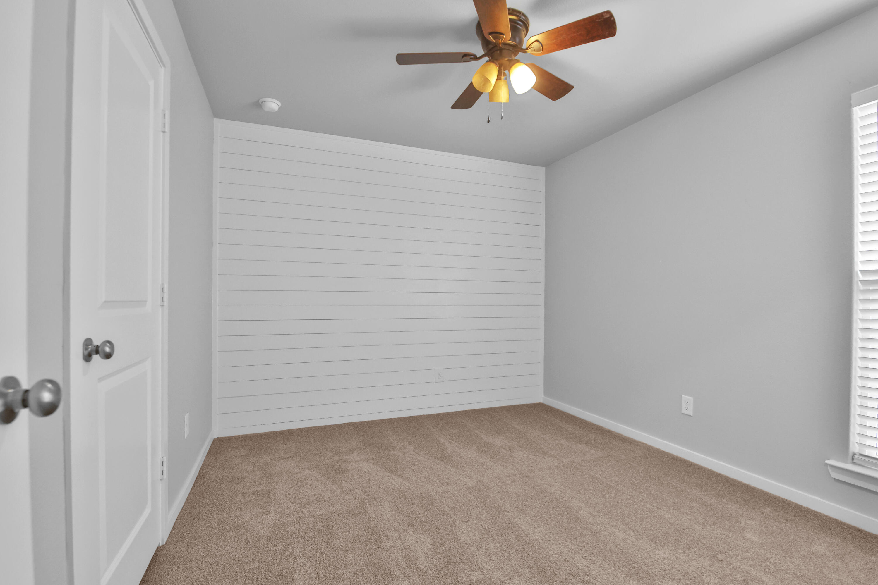 7526 104th Street Lubbock, TX 79424 - Photo 22 of 28 an empty room with a chandelier fan and a chandelier fan