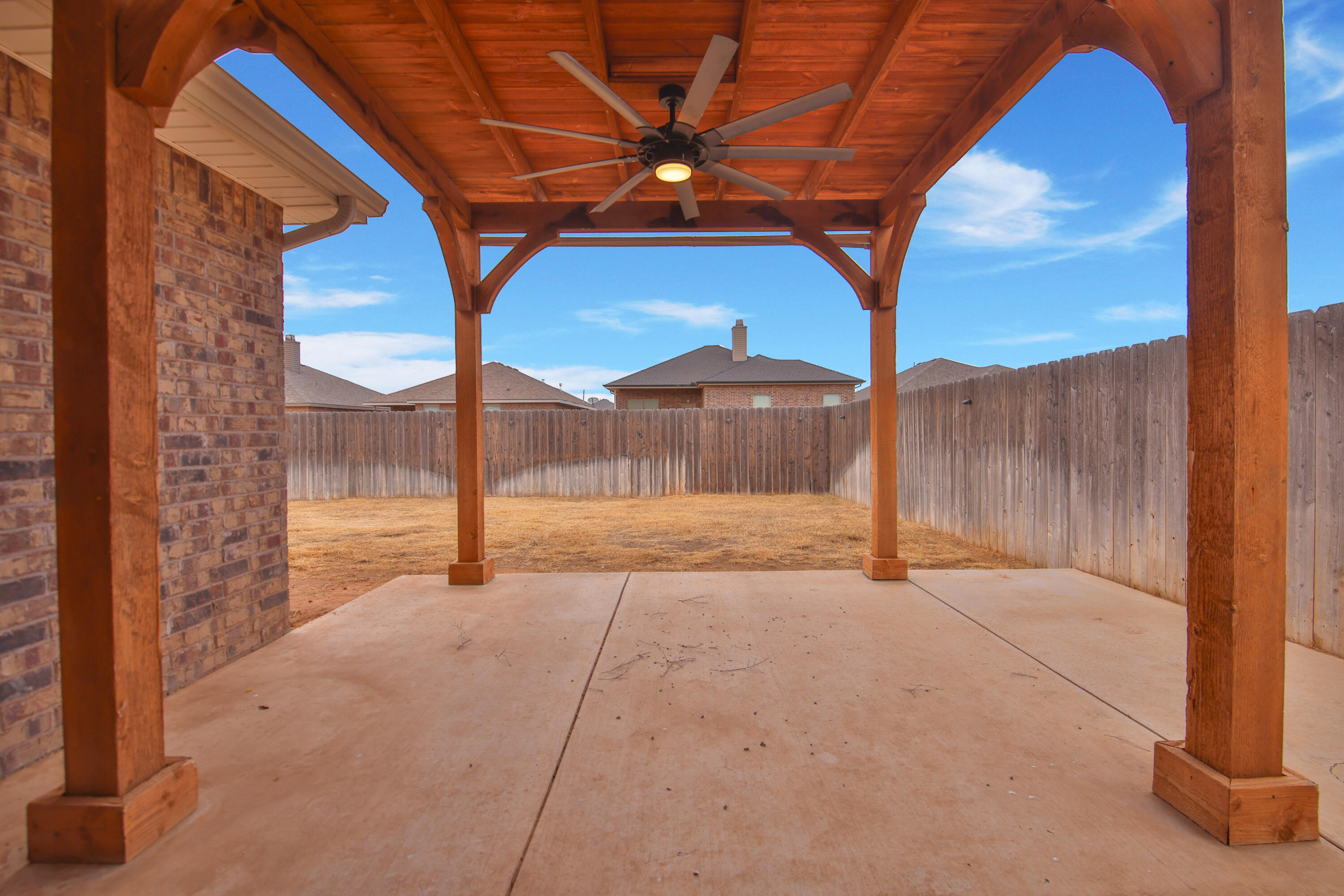 7526 104th Street Lubbock, TX 79424 - Photo 25 of 28 a view of backyard with a small yard and a tub