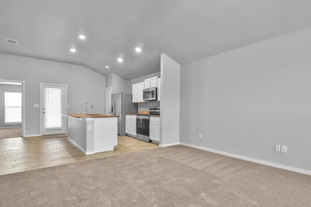 a view of kitchen with furniture and refrigerator