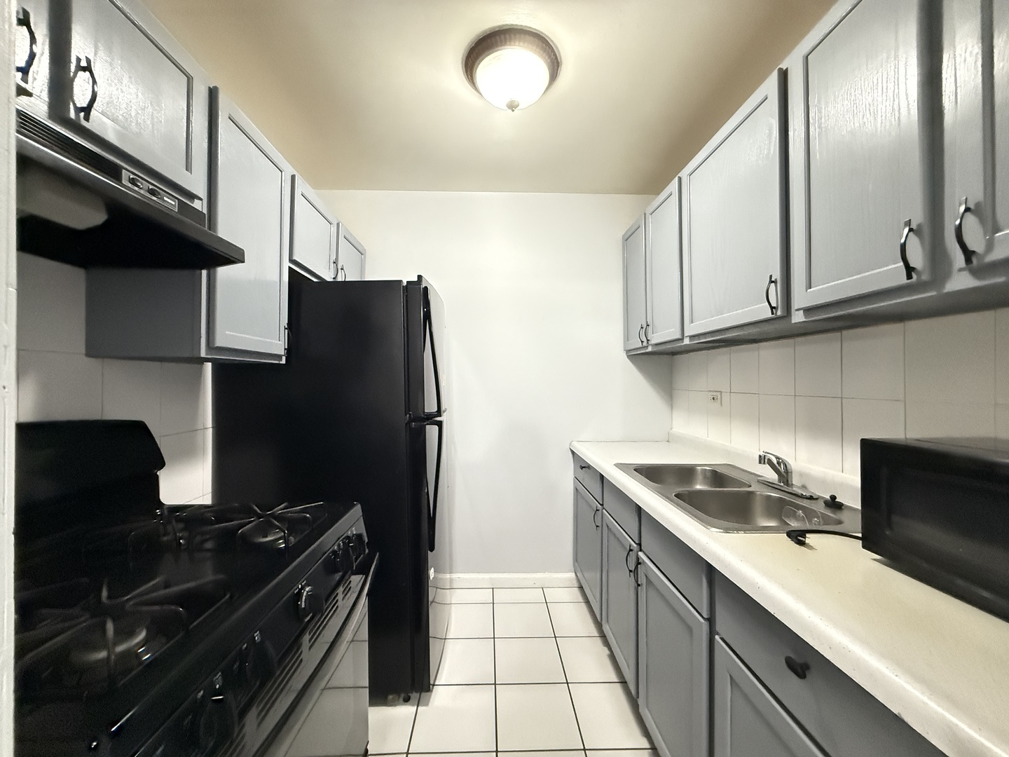600 Mesa Drive, Unit 104 Hoffman Estates, IL 60169 - Photo 9 of 12 a kitchen with stainless steel appliances a sink stove and refrigerator