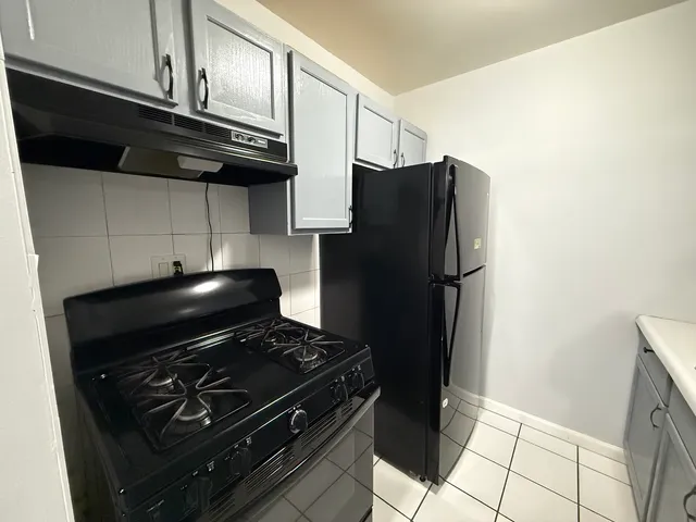 a stove top oven sitting inside of a kitchen