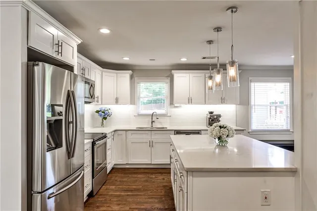 a kitchen with stainless steel appliances a sink stove and refrigerator