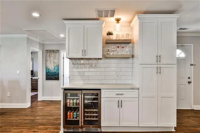 a kitchen with stainless steel appliances a refrigerator and cabinets