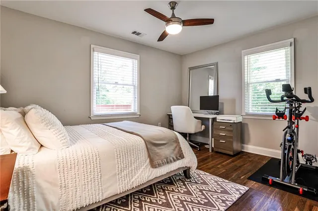 a bed room with a bed and a chair