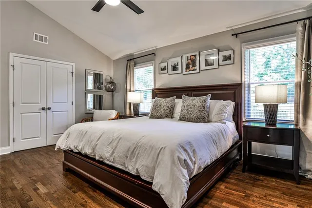 a bedroom with a bed and wooden floor