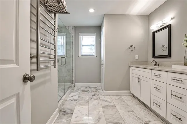 a bathroom with a sink a mirror and a shower